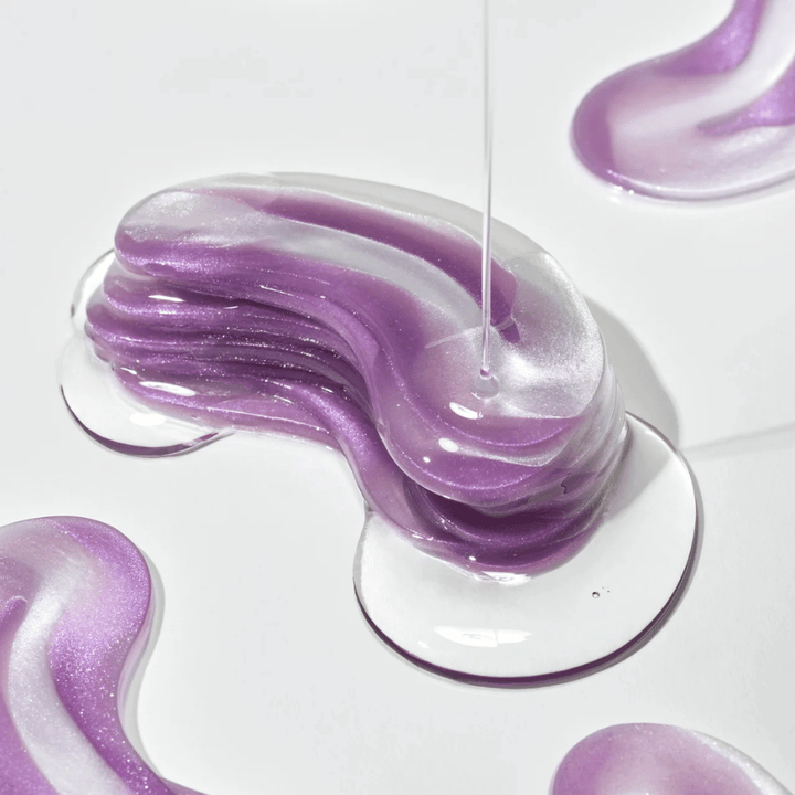 Purple hydrogel texture from 360° Shot PDRN Glowing Eye Patch with shimmering layers showing moisturizing and radiance-enhancing consistency for the eye area.