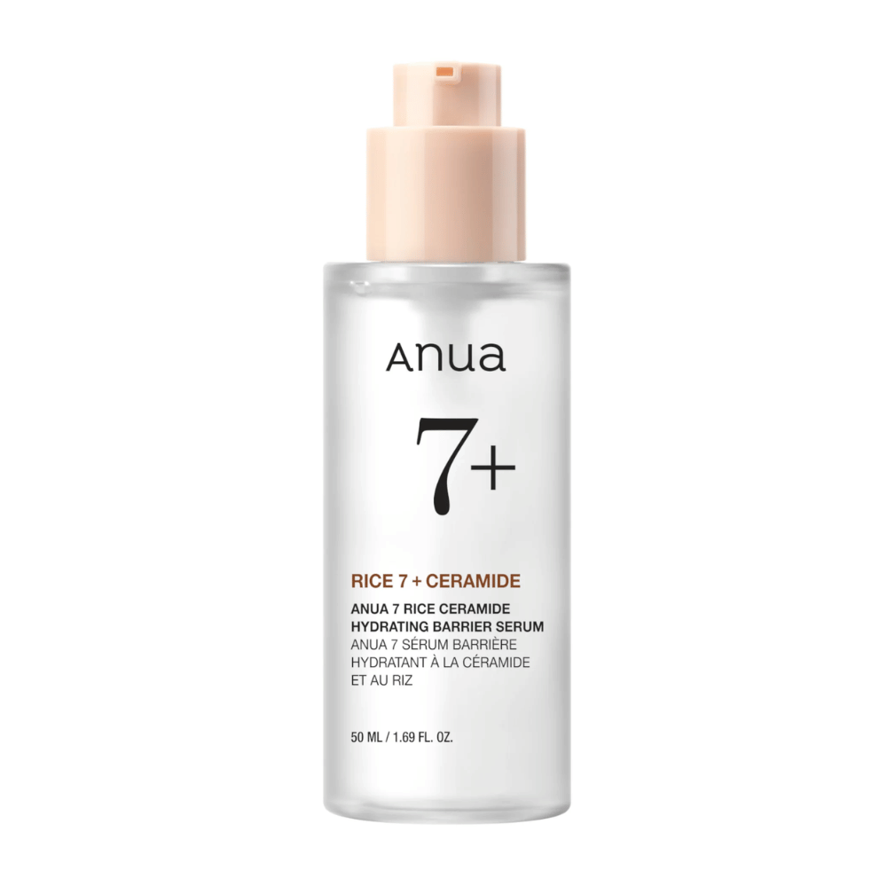A bottle of "Anua 7+ Rice Ceramide Hydrating Barrier Serum" with a clear and minimalist design. The packaging is transparent with a light pink pump, and contains 50 ml of serum enriched with rice and ceramides to hydrate and strengthen the skin's barrier.