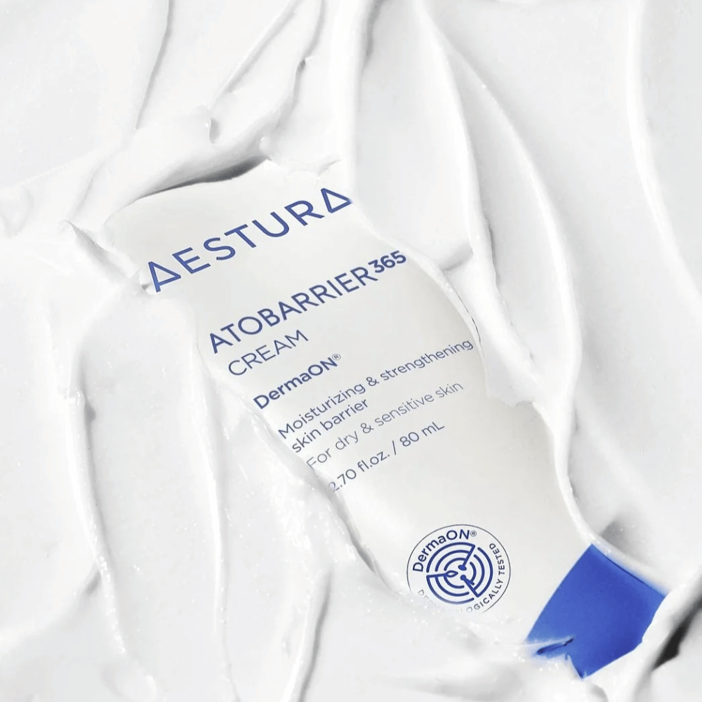 Aestura Atobarrier 365 Cream is perfect for dry and sensitive skin. With DermaON™ technology, this cream moisturizes and strengthens the skin barrier. The product is shown here in an 80 ml tube, partially covered by its own creamy texture, highlighting its rich, moisturizing properties.