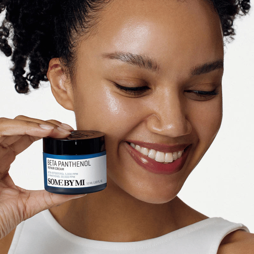 Model with glowing skin holding SOME BY MI Beta Panthenol Repair Cream – Korean face cream that strengthens the skin barrier and hydrates.