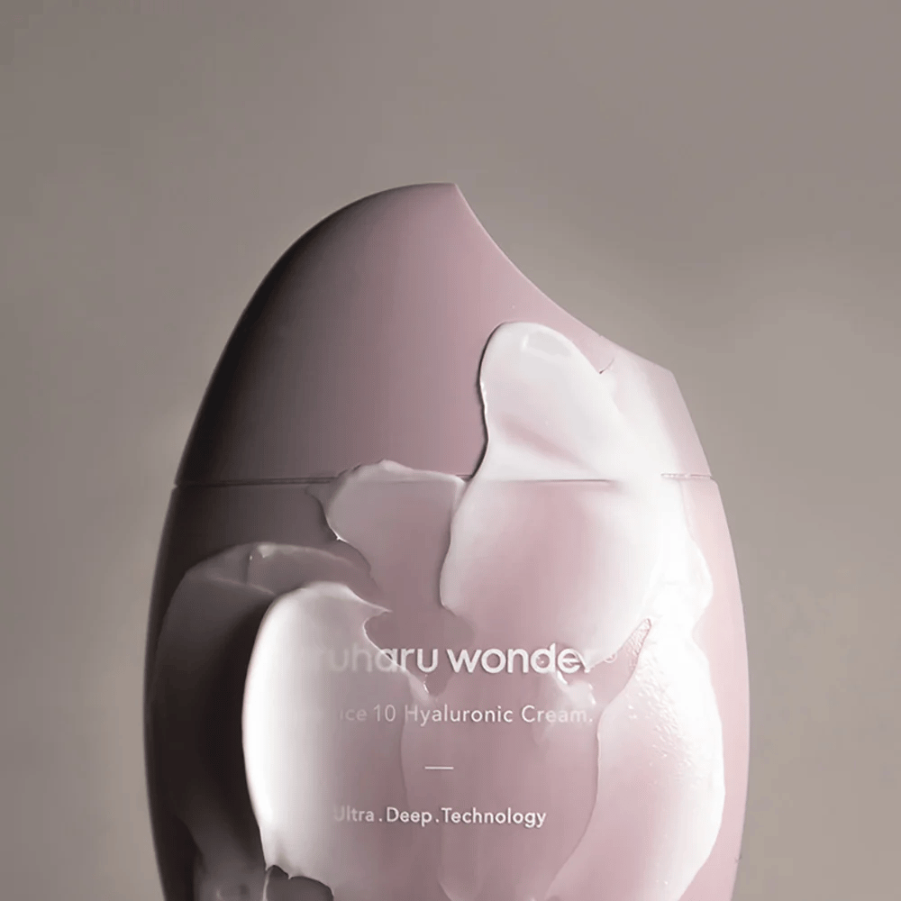 The image shows a jar of "Haruharu Wonder Black Rice 10 Hyaluronic Cream", which is partially covered by a thick, transparent cream. The text on the image suggests the use of advanced technology for deep skin hydration. The design is modern and minimalist.