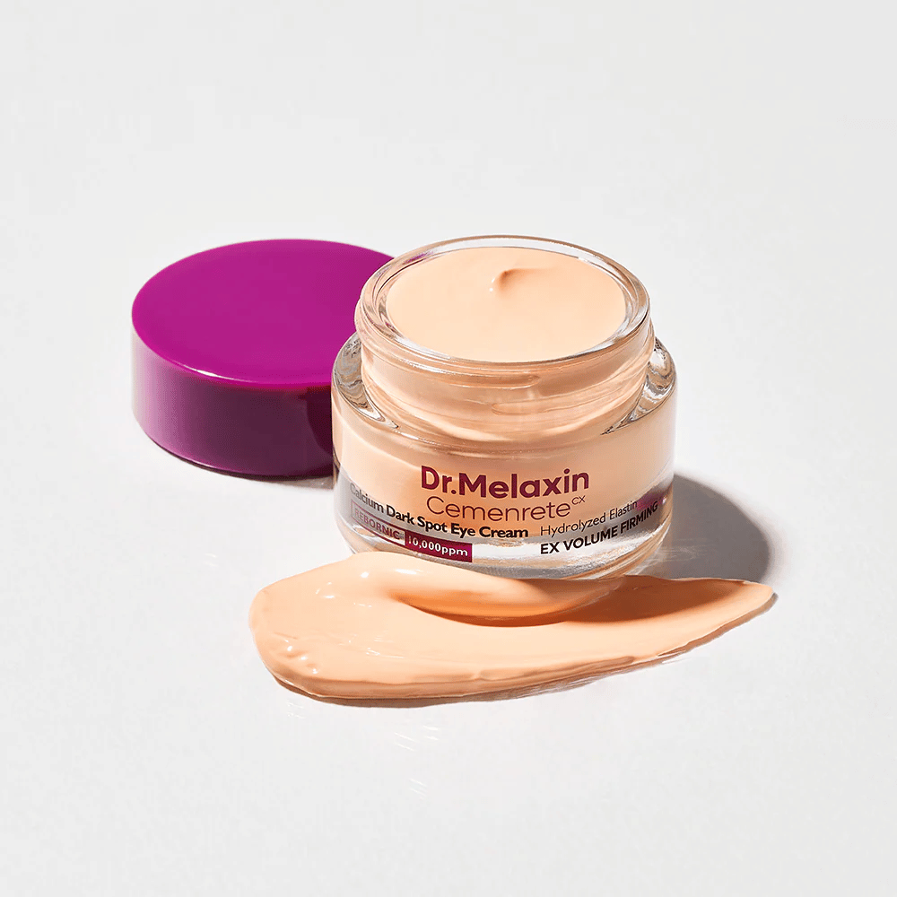Dr.Melaxin Cemenrete Calcium Dark Spot Eye Cream in an open jar with cream texture, eye cream that helps reduce dark circles and provide firmer skin around the eyes.