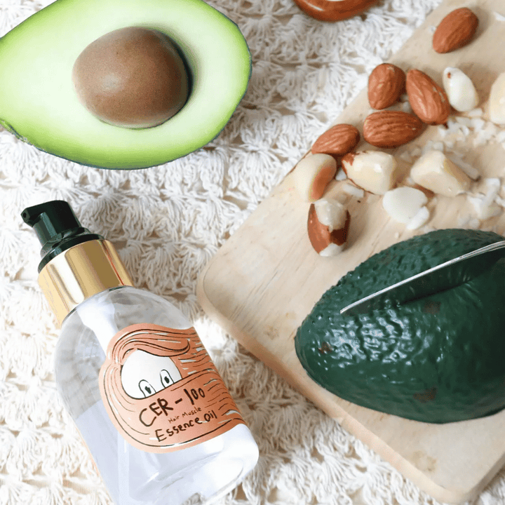 Elizavecca CER-100 Hair Muscle Essence Oil ingredients – close-up with avocado and plant oils showing a nutritious hair oil that helps soften and nurture the hair.