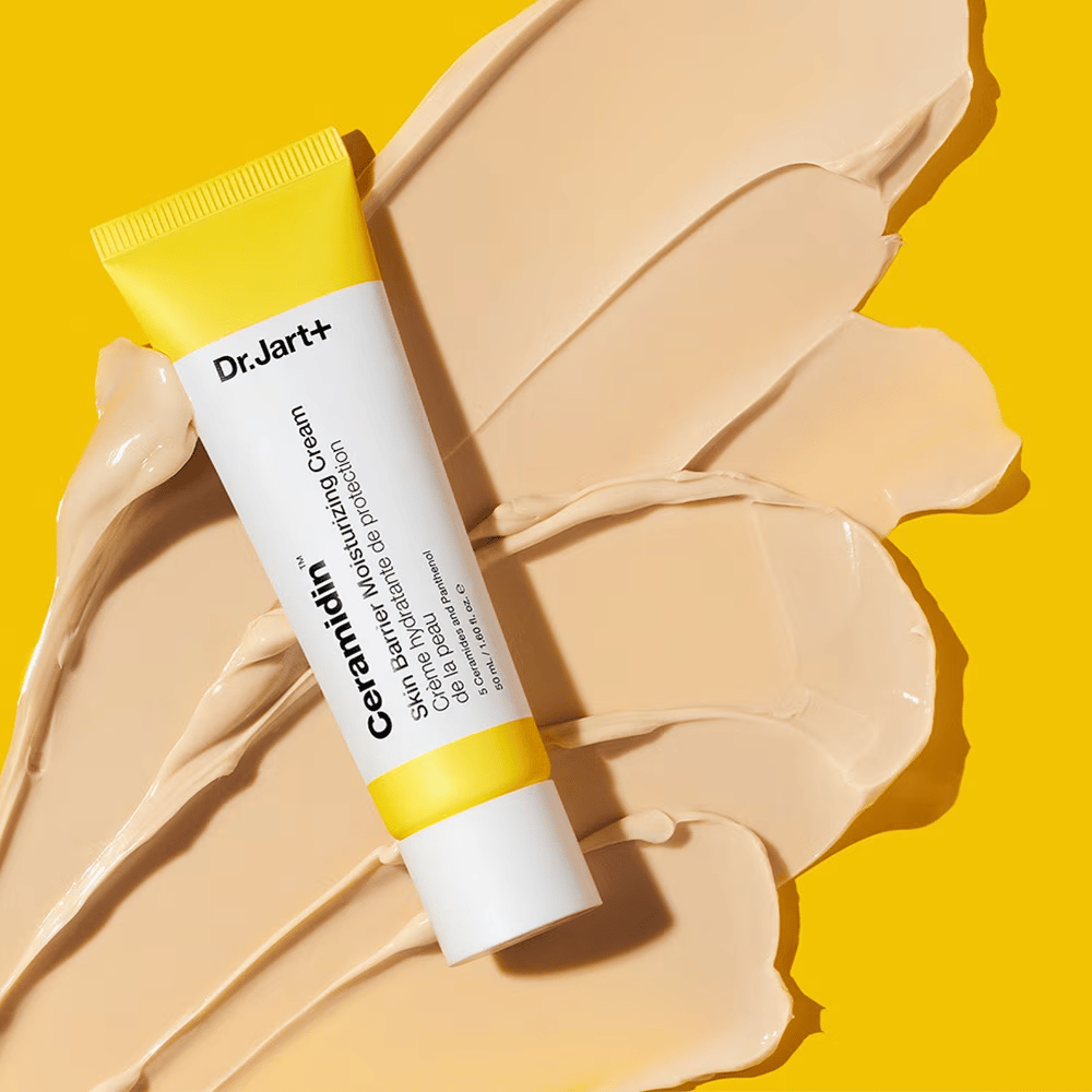 Tube with Dr. Jart+ Ceramidin Skin Barrier Moisturizing Cream against a yellow background with cream spread out.