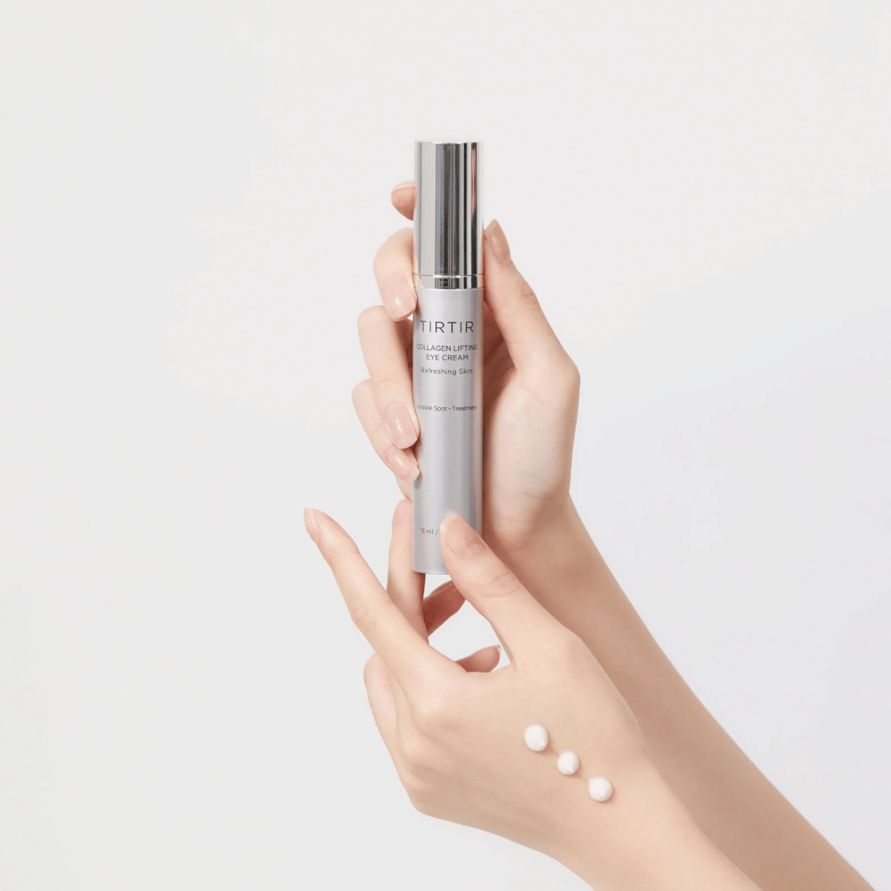 Hands holding a tube with TIRTIR Collagen Lifting Eye Cream, with product squeezed onto the back of the hand.
