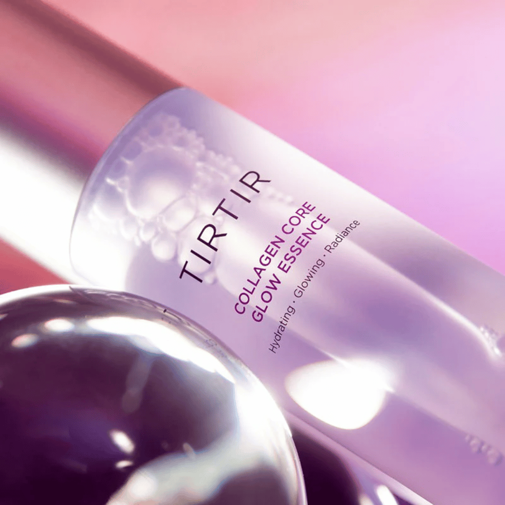 Close-up of TIRTIR Collagen Core Glow Essence – radiance-enhancing essence in an elegant purple bottle focusing on hydration and the skin's natural glow.