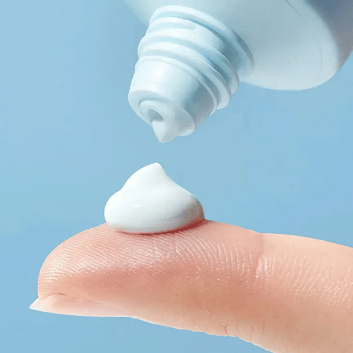 Close-up of Torriden DIVE-IN Moisture Sun Cream with a soft, moisturizing texture dispensed onto the fingertip for daily sun protection.