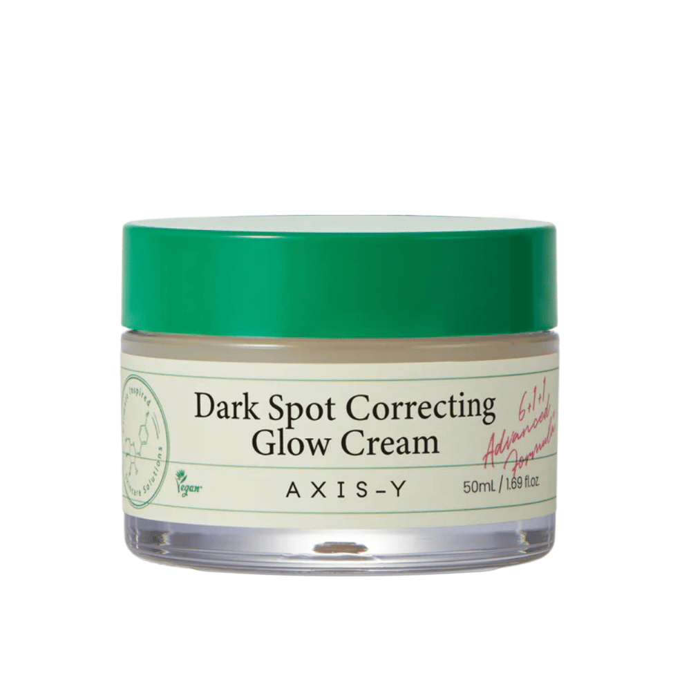 A jar of "AXIS-Y Dark Spot Correcting Glow Cream". This cream is intended to correct dark spots and give the skin radiance. The packaging is elegant with a transparent bottom and an eye-catching green lid.