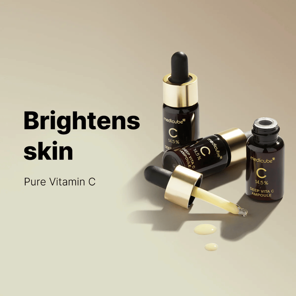Medicube Deep Vita C Ampoule with 14.5% Vitamin C, displayed in elegant bottles with gold-colored droppers. The product is designed to brighten the skin tone and give a radiant complexion. The text "Brightens skin" and "Pure Vitamin C" reinforce the message.