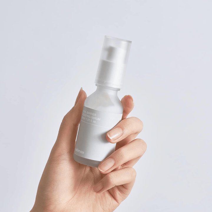 Celimax Dual Barrier Boosting Serum in hand, minimalist packaging showing barrier-strengthening Korean serum for sensitive skin.