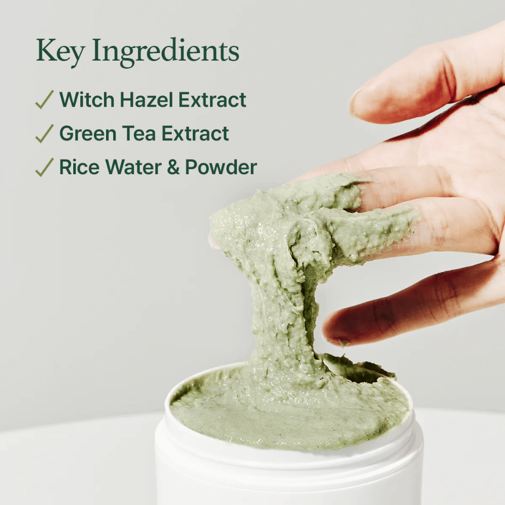 A hand lifts Arencia Fresh Green Rice Mochi Cleanser from a jar. The green, viscous cream stretches between the fingers. The text lists ingredients: Witch Hazel, Green Tea, Rice Water & Powder.