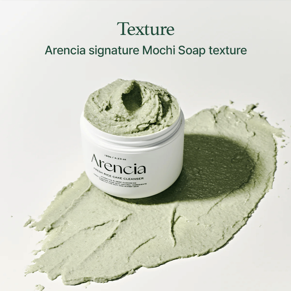 Arencia Fresh Rice Cake Cleanser in an open jar with creamy green mochi-like texture spread around the jar on a white surface.