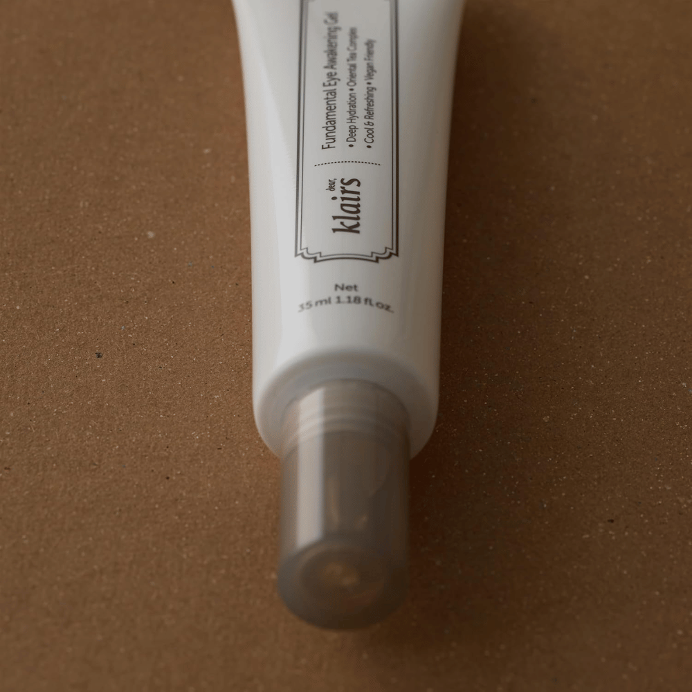 Close-up of the tube’s transparent cap and lower section. The image highlights the sleek packaging design and the hygienic applicator that protects the product between uses.