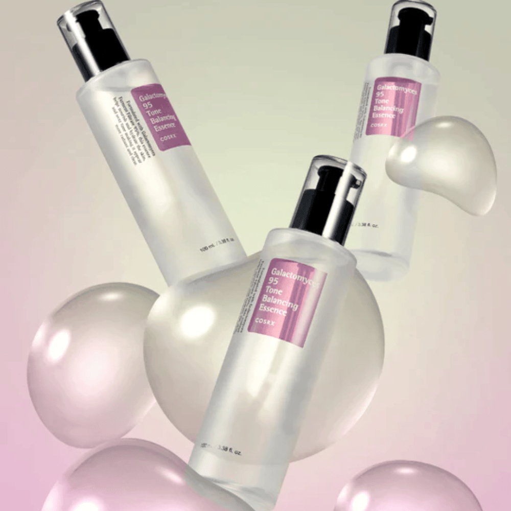 Three bottles of COSRX Galactomyces 95 Tone Balancing Essence surrounded by bright bubbles. Skin-enhancing essence that evens out skin tone and provides natural glow.