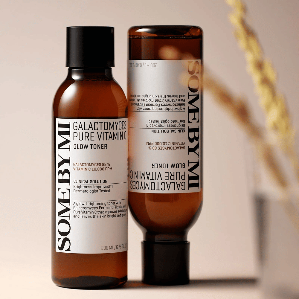 Image of SOME BY MI Galactomyces Pure Vitamin C Glow Toner. The bottles have a sleek design with brown tones and a black cap. The product contains 88% galactomyces and 10,000 ppm vitamin C, which promises to improve skin radiance and provide a fresher skin tone.