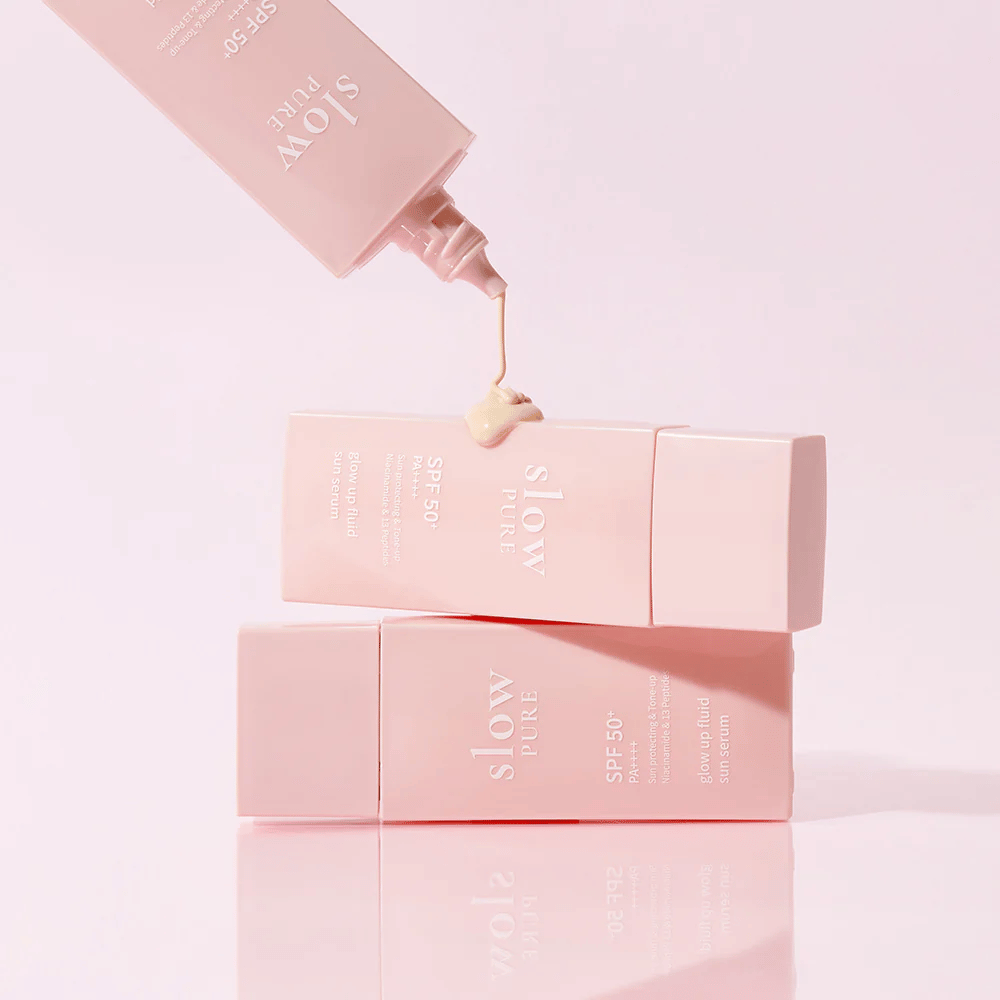 Slow Pure Glow Up Fluid Sun Serum with cream pressed out of the bottle, shows light and caring consistency.