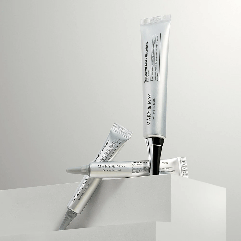 Mary&May Tranexamic Acid + Glutathione Eye Cream set up in studio, Korean eye cream combining tranexamic acid and glutathione for a clearer look.