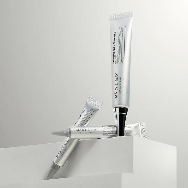 Mary&May Tranexamic Acid + Glutathione Eye Cream set up in studio, Korean eye cream combining tranexamic acid and glutathione for a clearer look.