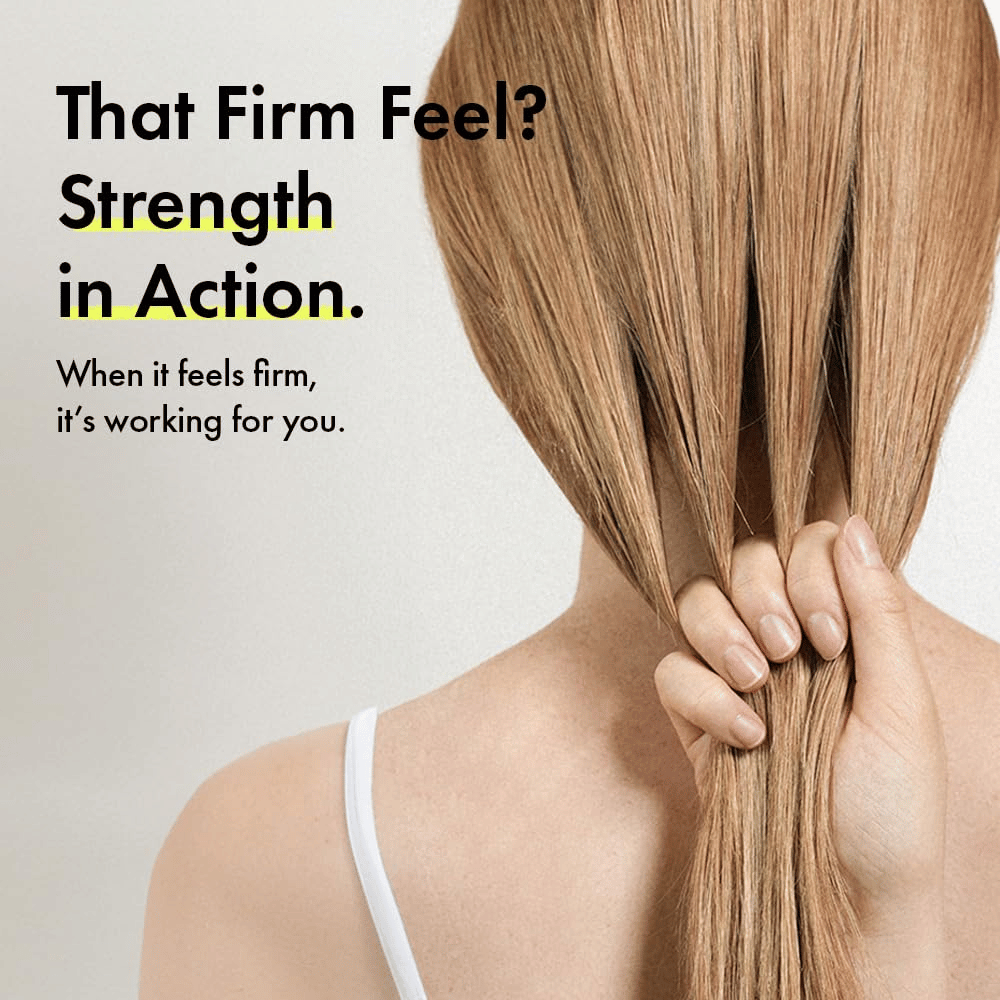 Person holding their hair to illustrate stronger hair strands and a firmer hair feel after using Grabity g0.0 Hair Lifting Shampoo Strong.