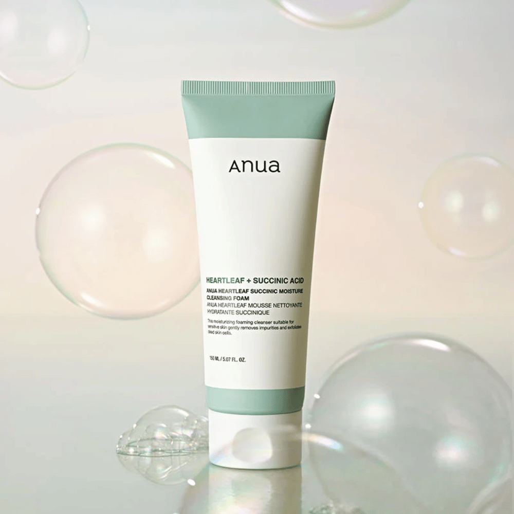 Product image of Anua Heartleaf + Succinic Acid Moisture Cleansing Foam surrounded by transparent bubbles. The image enhances the feeling of gentle cleansing, freshness, and airy foam.