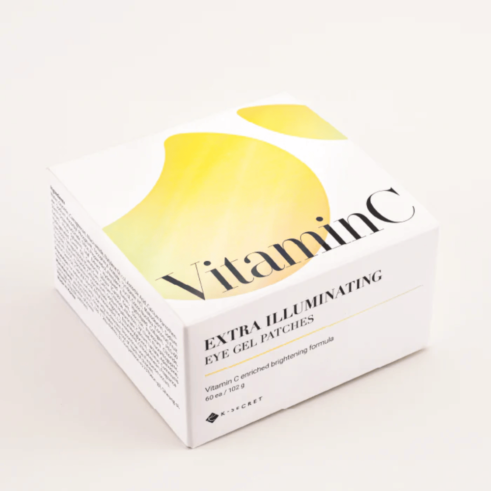 Förpackning av K-Secret Extra Illuminating Eye Gel Patches med vitamin C i vit och gul design.