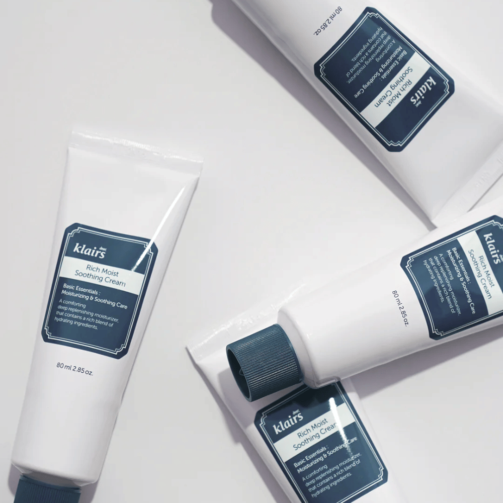 Several tubes of Klairs Rich Moist Soothing Cream strategically placed on a light surface, with shadows creating depth.