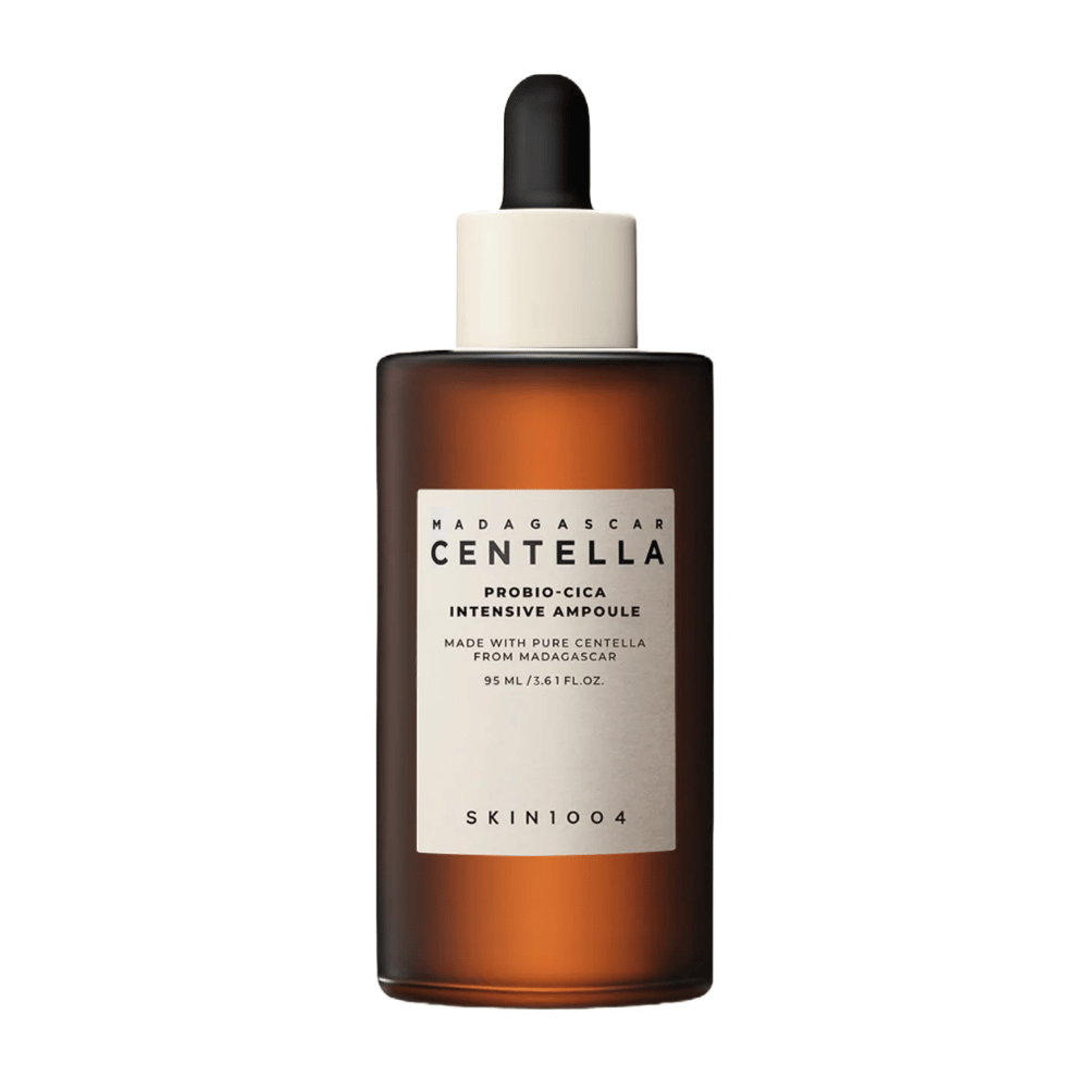 Brown glass bottle with dropper of SKIN1004 Madagascar Centella Probio-Cica Intensive Ampoule against a solid background.