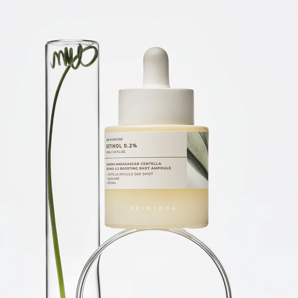 SKIN1004 Madagascar Centella Retinol 0.2 Boosting Shot Ampoule in a lifestyle image with botanical elements – facial serum that supports skin renewal and strengthens the skin barrier.