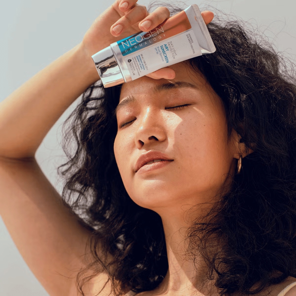 Neogen Dermalogy Day-Light Protection Airy Sunscreen SPF50 50ml – lightweight sunscreen with broad-spectrum UV protection, shown in use in sunlight.