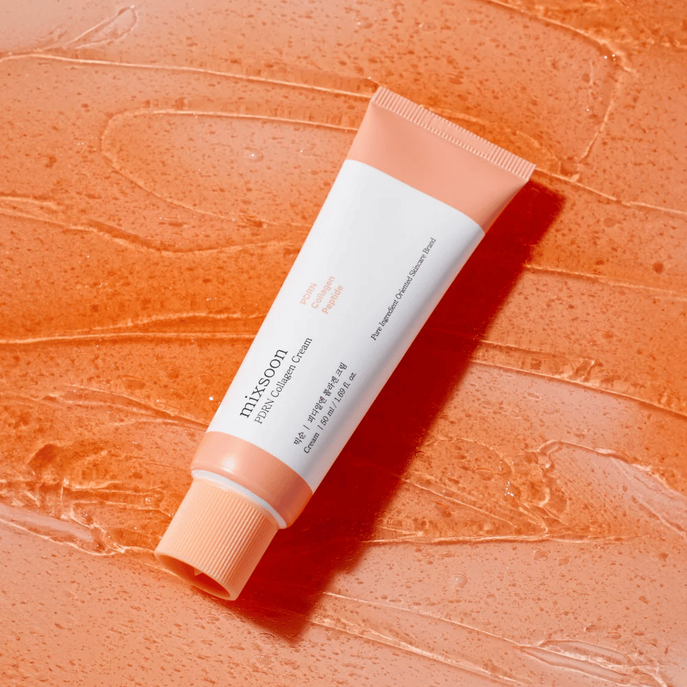 Mixsoon PDRN Collagen Cream lies on a glossy orange background. A nourishing face cream with PDRN, collagen, and peptides for firmer skin.