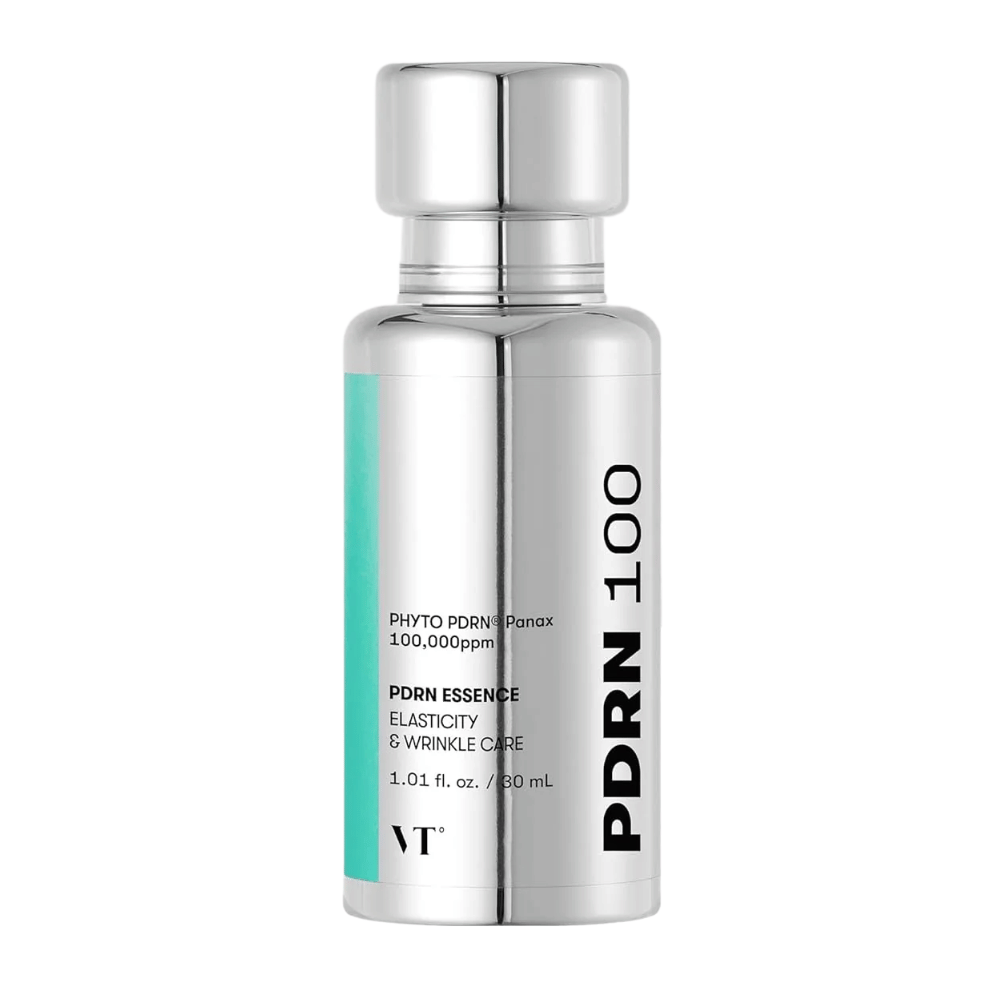 VT PDRN 100 Essence in a silver-colored bottle with text indicating content: 100,000 ppm PHYTO PDRN® Panax for elasticity and wrinkle care. The bottle holds 30 ml and has an elegant, mirror-like design.