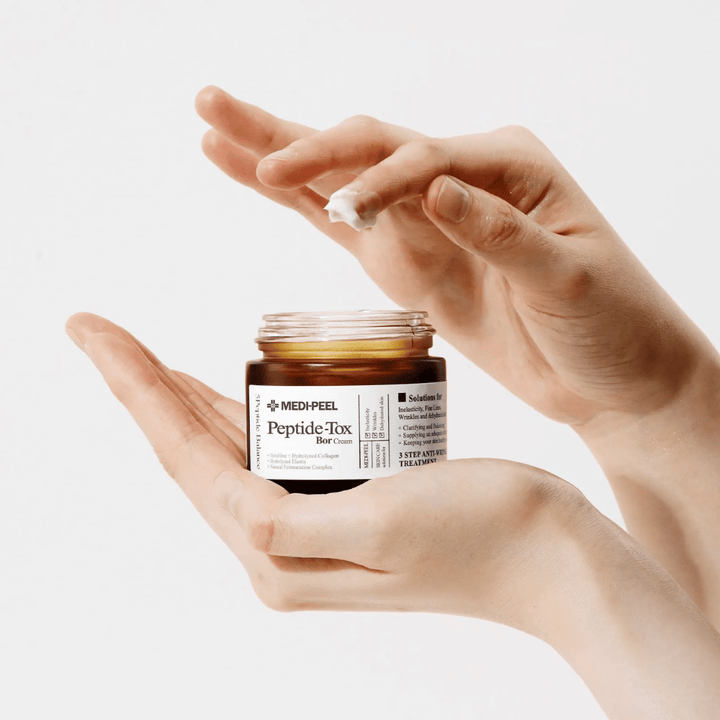 Application of MEDI-PEEL Peptide-Tox Bor Cream – Korean face cream with peptides that improve skin elasticity, provide deep hydration, and help reduce wrinkles.