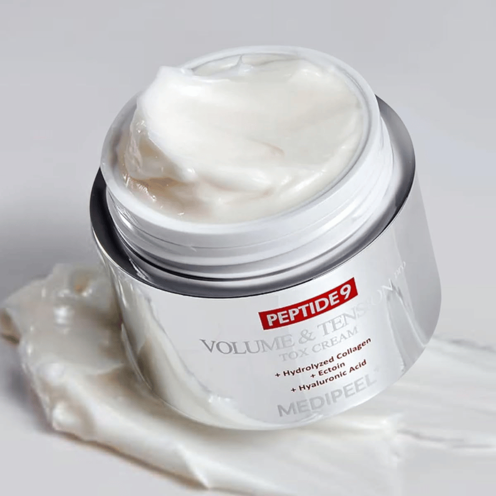 Close-up of MEDI-PEEL Peptide 9 Volume & Tension Tox Cream. The rich cream contains hydrolyzed collagen, ectoin, and hyaluronic acid for firmer and hydrated skin.