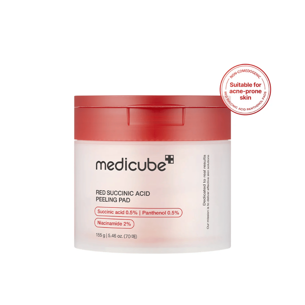 Medicube Red Succinic Acid Peeling Pad in a white jar with a red lid, designed for acne-prone skin. Contains succinic acid, panthenol, and niacinamide to improve skin texture and provide gentle exfoliation. Non-comedogenic formula.