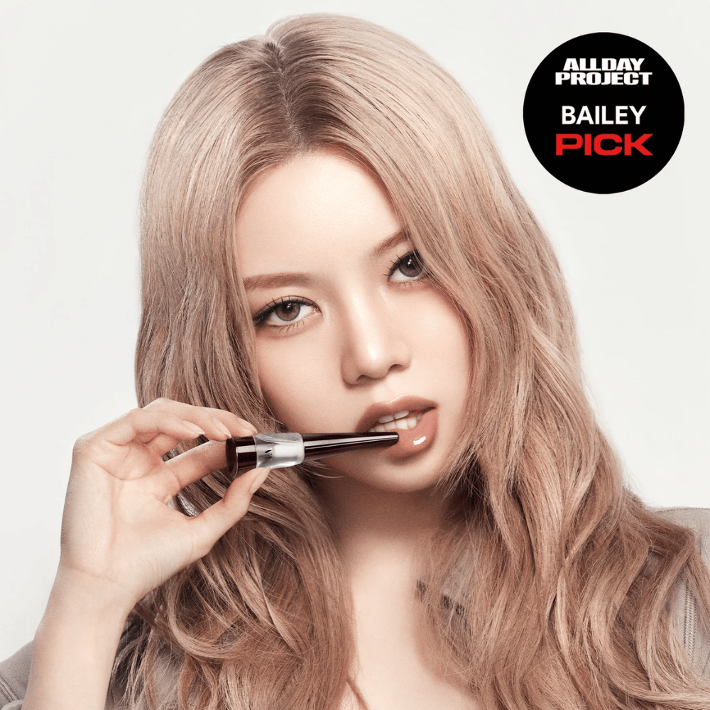 Model applies VT Reedle Shot Lip Plumper Expert on the lips, glossy finish, and fuller lips, marked as Bailey Pick from All Day Project.