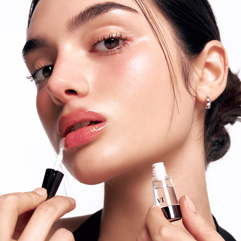 Model applies VT Cosmetics Reedle Shot Lip Plumper Beginner on the lips for natural plumping, shine, and hydration with a light tingling effect.