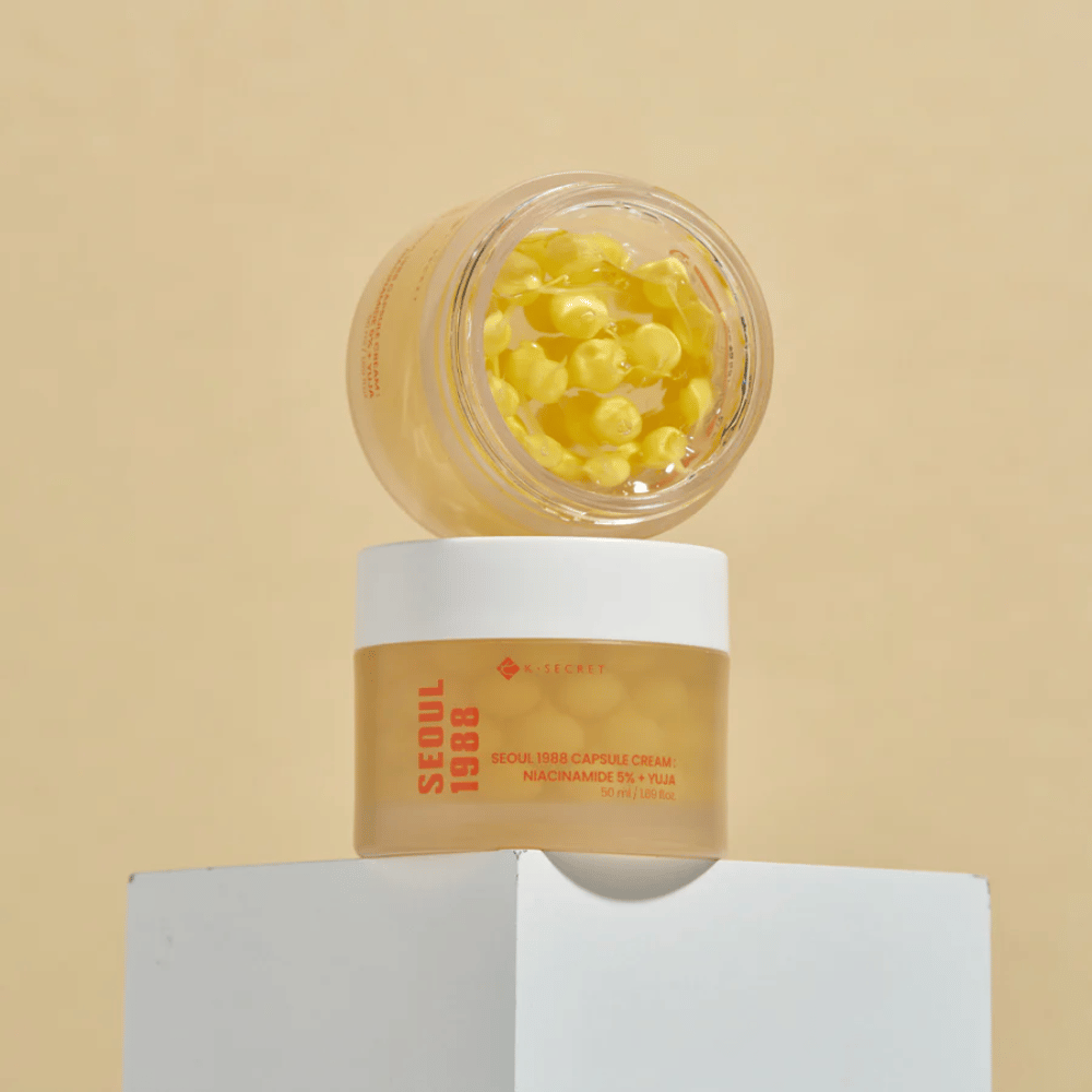 Stylish arrangement: Two jars with Seoul 1988 Capsule Cream, one open and one closed, placed against a beige background.