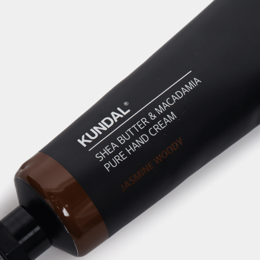 Close-up of KUNDAL Shea Butter & Macadamia Pure Hand Cream Jasmine Woody showing the sleek packaging and the hand cream's premium feel.