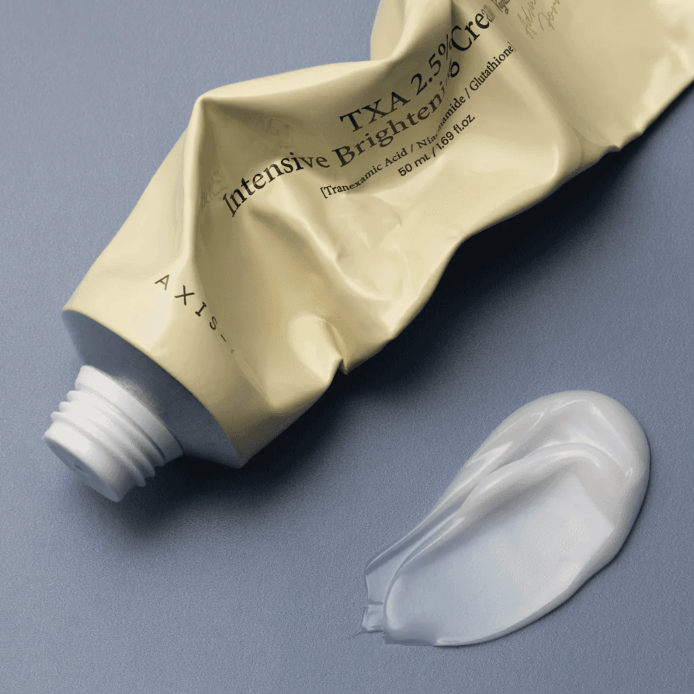Product image with the tube and a dollop of cream beside it to show the soft, creamy texture and hydrating formula. The focus is on glow and even application.
