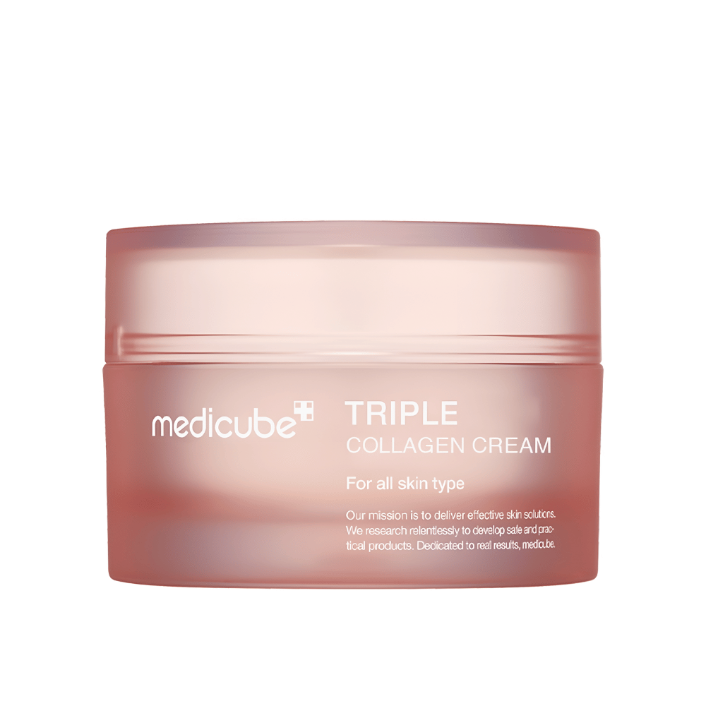 The image shows a container of Medicube Triple Collagen Cream. This face cream is developed for all skin types and promises to improve skin elasticity and moisture levels. The design is minimalist with a soft pink tone on the packaging.