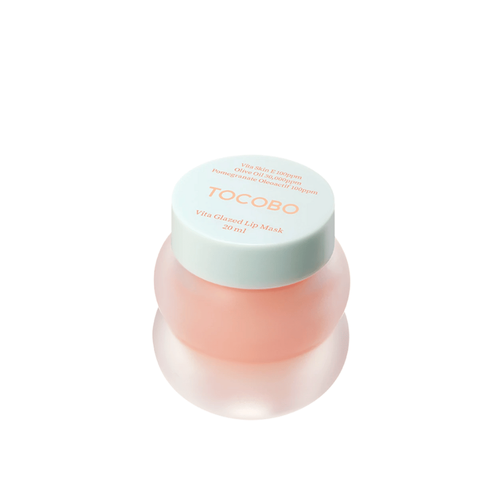 A jar of "Vita Glazed Lip Mask" from Tocobo is displayed. The jar is round and transparent with a light turquoise lid. The mask inside is light pink and designed to moisturize and care for the lips. The product has a volume of 20 ml.