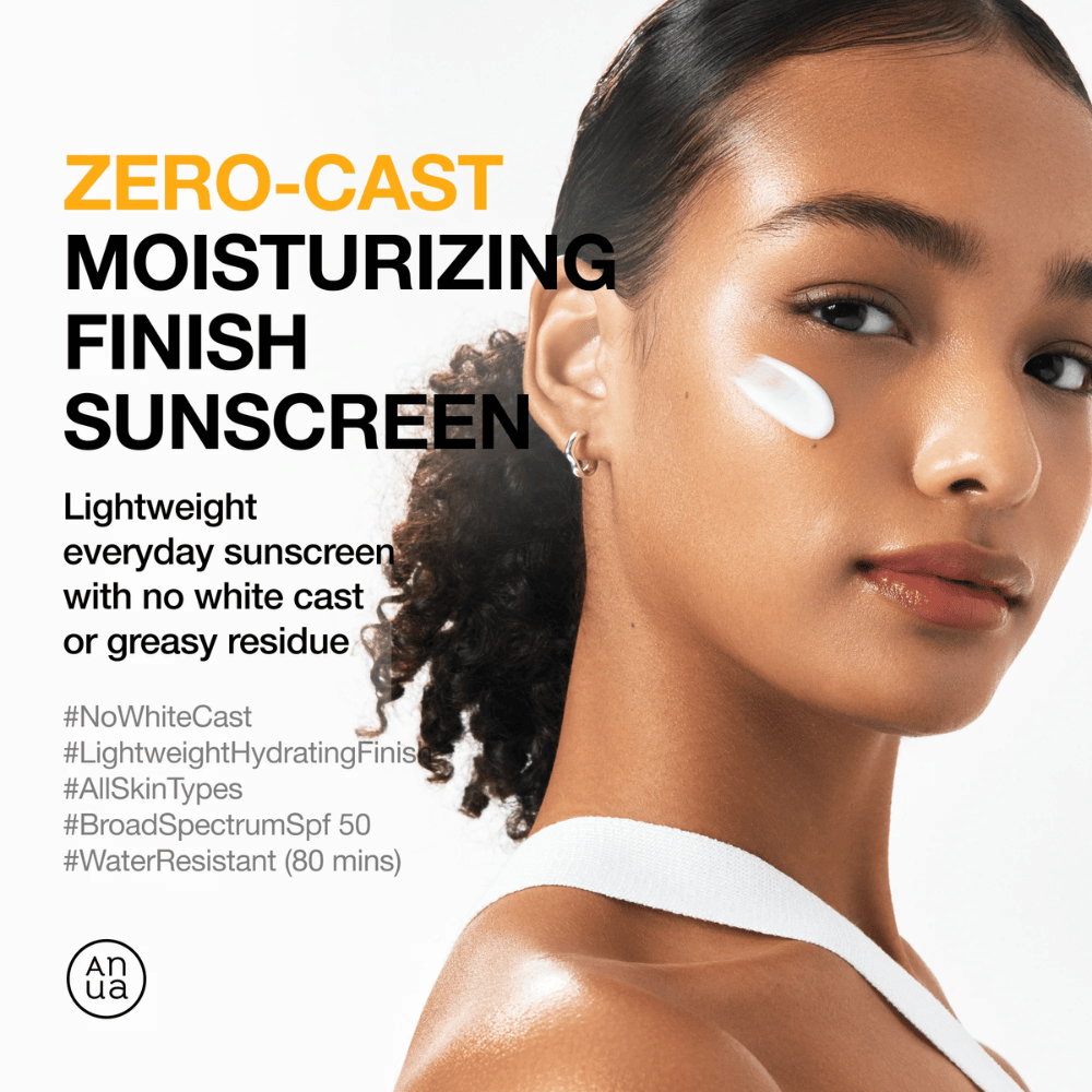 Woman with sunscreen on her cheek shows ANUA Zero-Cast Moisturizing Finish Sunscreen – a lightweight, moisturizing sunscreen with SPF 50 that does not leave a white cast.