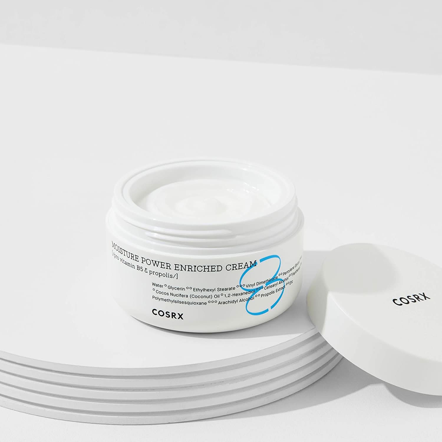 A jar COSRX Moisture Power Enriched Cream 50ml sitting on a table.