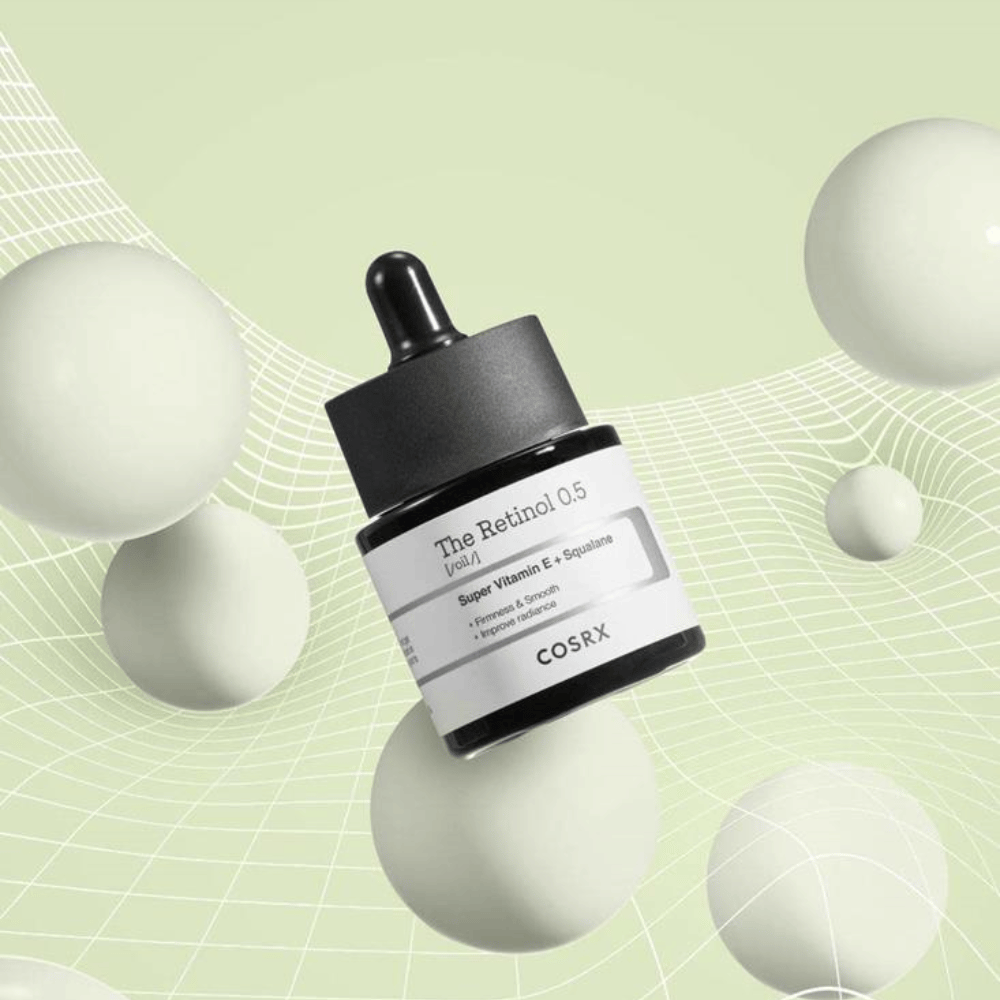 A bottle of COSRX Retinol 0.5 Oil 20ml that promotes anti-aging benefits on a white background.